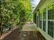 Serene backyard patio with a screened-in porch and lush greenery, providing a peaceful outdoor retreat at 320 Easton Grey Loop, Cary, NC 27519