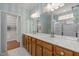 Well lit bathroom featuring a double vanity and a walk in shower with glass doors at 320 Easton Grey Loop, Cary, NC 27519