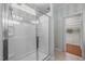 This bathroom features a modern glass shower enclosure and a view into the closet at 320 Easton Grey Loop, Cary, NC 27519