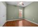 Cozy bedroom with hardwood floors, natural light, and neutral paint at 320 Easton Grey Loop, Cary, NC 27519