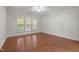 Spacious bedroom with hardwood floors, large windows, neutral paint, and ceiling fan with light at 320 Easton Grey Loop, Cary, NC 27519