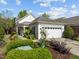 Charming single-story home with a well-manicured lawn, mature landscaping, and an attached two-car garage at 320 Easton Grey Loop, Cary, NC 27519