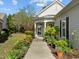 Inviting front entrance framed by lush landscaping leading to a charming, well-lit doorway at 320 Easton Grey Loop, Cary, NC 27519