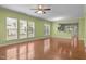 Open-concept living room with hardwood floors, natural light, and view of the kitchen at 320 Easton Grey Loop, Cary, NC 27519