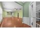 Open-concept living room featuring hardwood floors, neutral walls, and a view to the kitchen at 320 Easton Grey Loop, Cary, NC 27519