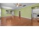 Open-concept living room offering hardwood floors, a view to the kitchen, and modern appliances at 320 Easton Grey Loop, Cary, NC 27519