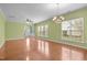 Bright, open living room with hardwood floors, large windows, modern fixtures, and neutral walls at 320 Easton Grey Loop, Cary, NC 27519