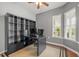 Spacious home office featuring gray walls, hardwood floors, and an ample storage unit at 320 Easton Grey Loop, Cary, NC 27519