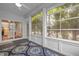 Bright sunroom with large windows, ceiling fan, view to kitchen, and an area rug on composite flooring at 320 Easton Grey Loop, Cary, NC 27519