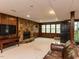 Finished basement includes a stone fireplace, wood paneling, carpeted floor and leather couch at 3320 Marblehead Ln, Raleigh, NC 27612