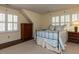 Bedroom featuring light blue decor, neutral walls, shuttered windows, and wood furnishings at 3320 Marblehead Ln, Raleigh, NC 27612