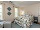 Bedroom featuring a patterned bedspread, neutral walls, and hardwood floors with blue carpet at 3320 Marblehead Ln, Raleigh, NC 27612