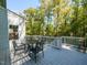 Back deck with metal table and chair, and white railings offering a serene space for outdoor relaxation at 3320 Marblehead Ln, Raleigh, NC 27612