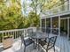 Outdoor deck with a table, chairs and white railing providing the perfect outdoor entertainment and enjoyment at 3320 Marblehead Ln, Raleigh, NC 27612