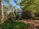 Charming two-story home with blue shutters surrounded by lush greenery and mature trees at 3320 Marblehead Ln, Raleigh, NC 27612