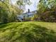 Exterior shot showcases a home with a well-manicured lawn and a multi-tiered deck with lots of greenery at 3320 Marblehead Ln, Raleigh, NC 27612
