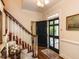 Elegant foyer features a hardwood floor, staircase, and a front door with glass panes at 3320 Marblehead Ln, Raleigh, NC 27612