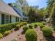 Landscaped front yard featuring green bushes lining a stone walkway leading to a light blue home at 3320 Marblehead Ln, Raleigh, NC 27612