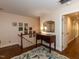 Hallway with hardwood flooring, complemented by neutral paint and a decorative table with a mirror at 3320 Marblehead Ln, Raleigh, NC 27612