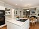 Modern kitchen with white cabinets, stainless steel appliances, and cooktop island perfect for entertaining and cooking at 3320 Marblehead Ln, Raleigh, NC 27612