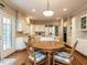 Spacious kitchen features white cabinetry, stainless steel appliances, eat-in table and hardwood floors at 3320 Marblehead Ln, Raleigh, NC 27612
