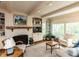 Cozy living room features a brick fireplace, built-in bookshelves, and large windows with natural light at 3320 Marblehead Ln, Raleigh, NC 27612