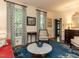 Cozy living room with hardwood floors, a blue rug, and bright, natural light at 3320 Marblehead Ln, Raleigh, NC 27612
