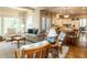 Inviting living room seamlessly connects to the kitchen and features hardwood floors, lots of natural light and a patterned wallpaper at 3320 Marblehead Ln, Raleigh, NC 27612