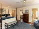 View of main bedroom featuring a four-poster bed, ensuite bathroom, and windows at 3320 Marblehead Ln, Raleigh, NC 27612
