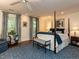 Spacious main bedroom featuring a four-poster bed, blue accents, windows, and carpet at 3320 Marblehead Ln, Raleigh, NC 27612