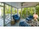 Comfortable screened-in porch with seating, ceiling fan, string lights, and views of the backyard at 3320 Marblehead Ln, Raleigh, NC 27612