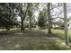Large backyard with scattered trees and a partial view of the side and back of the house at 3609 Hawthorne Rd, Rocky Mount, NC 27804