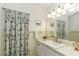 Bathroom with a large mirror, and a floral shower curtain at 3609 Hawthorne Rd, Rocky Mount, NC 27804
