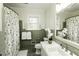 Well-lit bathroom with a shower, marble countertop, and floral accents for a fresh feel at 3609 Hawthorne Rd, Rocky Mount, NC 27804