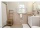 Bright bathroom featuring vintage pink tile, white vanity, and window with shutters at 3609 Hawthorne Rd, Rocky Mount, NC 27804
