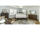 Bright bedroom with a queen bed, patterned rug, and natural light from multiple windows at 3609 Hawthorne Rd, Rocky Mount, NC 27804