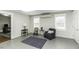 Spacious bonus room with two windows, an area rug and a comfortable chair at 3609 Hawthorne Rd, Rocky Mount, NC 27804