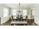 Traditional dining room with a large table, chandelier, and natural light from two windows at 3609 Hawthorne Rd, Rocky Mount, NC 27804