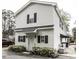 Two-story home featuring white siding, black shutters, and manicured landscaping at 3609 Hawthorne Rd, Rocky Mount, NC 27804