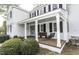 Inviting front porch with swing, bench, brick flooring, and classic architectural details at 3609 Hawthorne Rd, Rocky Mount, NC 27804
