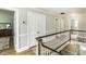 Well-lit hallway featuring wood floors, white trim, and a staircase with white balusters and wood railing at 3609 Hawthorne Rd, Rocky Mount, NC 27804