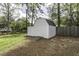 Backyard storage shed with a wooden ramp, sitting on a green lawn with bordering woods at 3609 Hawthorne Rd, Rocky Mount, NC 27804