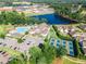 Stunning aerial shot featuring a pool, clubhouse, tennis courts, and picturesque landscaping at 39 Drayton St, Clayton, NC 27527