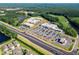 Aerial view of a shopping center, apartments, and residential community near a lake at 39 Drayton St, Clayton, NC 27527