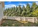 Fenced yard with green grass and tall privacy trees at 39 Drayton St, Clayton, NC 27527