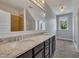 Bathroom with double sinks, granite countertop, dark cabinets, and a large mirror at 39 Drayton St, Clayton, NC 27527