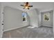A carpeted bedroom is well lit from two windows and includes a ceiling fan at 39 Drayton St, Clayton, NC 27527