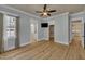 Bright bedroom with wood floors, ceiling fan, and doorway views to the closet and bathroom at 39 Drayton St, Clayton, NC 27527