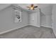 Carpeted bedroom with a closet, a ceiling fan, and a window allowing plenty of sunlight at 39 Drayton St, Clayton, NC 27527
