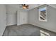 Well-lit carpeted bedroom with a ceiling fan, closet, and bright windows at 39 Drayton St, Clayton, NC 27527